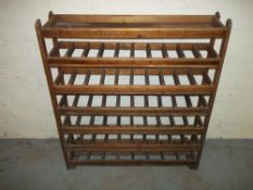 A SOLID MAHOGANY BOTTLE STORAGE RACK.