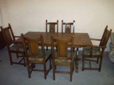 AN OLD CHARM OAK DINING SET A TABLE AND SIX CHAIRS INCLUDING TWO CARVERS.