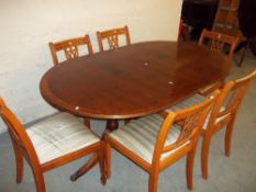 A YEW OVAL EXTENDING TABLE AND SIX CHAIRS.