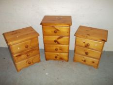 THREE SOLID PINE CHEST OF DRAWERS TO COMPRISE A FOUR DRAWER AND TWO THREE DRAWER BEDSIDES.