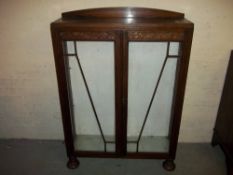 AN OAK CHINA CABINET.