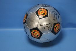 A FACSIMILE SIGNED MANCHESTER UNITED FOOTBALL TO INCLUDE RYAN GIGGS, RUUD VAN NISTELROOY,