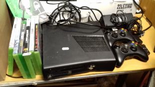 AN XBOX 360 AND ACCESSORIES TO INCLUDE TWO CONTROLLERS