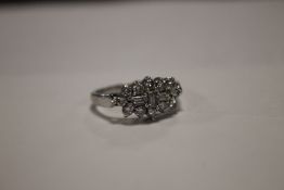 A LADIES WHITE METAL DRESS RING