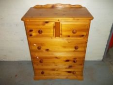 TWO OVER THREE FIVE DRAWER SOLID PINE CHEST OF DRAWERS.