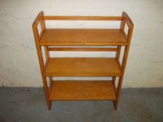 A FOLD AWAY WOODEN BOOK SHELF.
