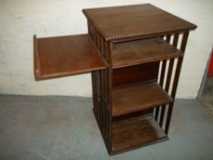 AN ANTIQUE OAK ROTATING TYPE BOOKSHELF.