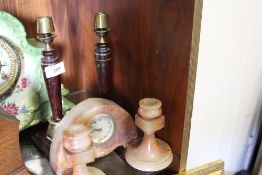 A PAIR OF BRASS AND TREEN CANDLESTICKS TOGETHER WITH AN ONYX CLOCK WITH MATCHING CANDLESTICKS