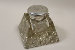 A LARGE HEAVY CUT GLASS DESK INKWELL WITH HALLMARKED SILVER MOUNTS - LONDON 1909