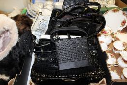 A TRAY OF MOSTLY MODERN LADIES HANDBAGS ETC. TOGETHER WITH A PAIR OF LEATHER COWBOY STYLE BOOTS