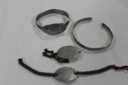 A PRISONER OF WAR STYLE BANGLE, TOGETHER WITH I.D BRACELETS