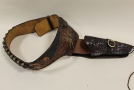 A VINTAGE EMBOSSED LEATHER GUN BELT
