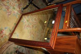 A CARVED WOODEN FRAMED WALL MIRROR