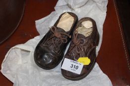 A PAIR OF SMALL VINTAGE LEATHER SHOES