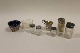 A COLLECTION OF SILVER TOPPED CRUETS ETC