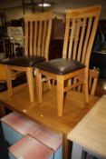 A MODERN OAK EXTENDING DINING TABLE AND 4 CHAIRS