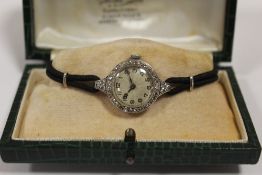 A LADIES VINTAGE PLATINUM AND DIAMOND SET WATCH - EACH BRILLIANT CUT DIAMOND APPROX 0.02 CARATS -
