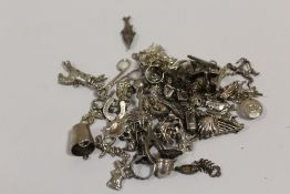 A LARGE QUANTITY OF SILVER BRACELET CHARMS