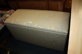 A MODERN UPHOLSTERED OTTOMAN