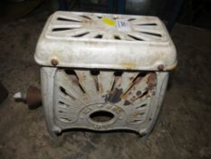 A VINTAGE CAST METAL KI-SOL BURNER OF SMALL PROPORTIONS