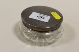 A HALLMARKED SILVER TOPPED VANITY JAR WITH FITTED MIRROR