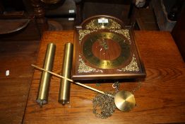 A MODERN TEMPUS FUGIT WALLCLOCK WITH TWIN WEIGHTS AND PENDULUM