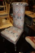 AN ANTIQUE PRIE DEUX CHAIR WITH MODERN UPHOLSTERY