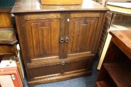 AN OAK LINENFOLD TELEVISION CABINET