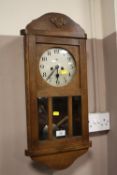 AN EDWARDIAN OAK WALL CLOCK