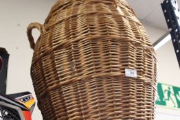 A TWIN HANDLED WICKER LAUNDRY BASKET
