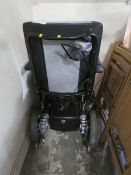 A YOU Q ELECTRIC WHEELCHAIR WITH KEY AND CHARGER