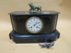 A VINTAGE SLATE MANTEL CLOCK WITH BRASS LION FINIAL