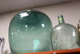 A LARGE GREEN GLASS DECORATE BOTTLE TOGETHER WITH A SMALL EXAMPLE