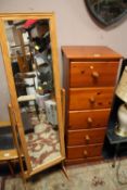 A HONEY PINE TALL FIVE DRAWER CHEST WITH A CHEVAL MIRROR
