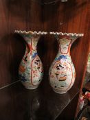 A PAIR OF ORIENTAL BALUSTER VASES WITH FRILLED RIMS, each vase decorated with a figure in a shaped