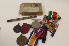 A COLLECTION OF MEDALS TO INCLUDE A ROYAL LIFE SAVING SOCIETY EXAMPLE, GOOD SAMARITAN MEDAL, RIBBONS