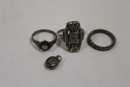 THREE SILVER DRESS RINGS TOGETHER WITH A MINIATURE SILVER LOCKET