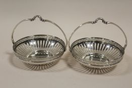 A PAIR OF WMF CIRCULAR SILVER PLATED BASKETS, with openwork and Greek key design border, basket