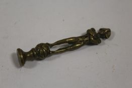 A VINTAGE BRASS PIPE TAMPER IN THE FORM OF NAPOLEON