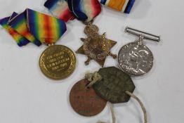A GROUP OF THREE WWI MEDALS AWARDED TO 13172 PTE. S. SMITH. N. STAFFS. R. AND DOG TAGS