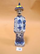 AN ORIENTAL BLUE AND WHITE FIGURE WITH IMPRESSED STAMPS TO BASE