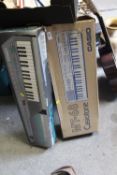 A BOXED YAMAHA KEYBOARD TOGETHER WITH A CASIO EXAMPLE
