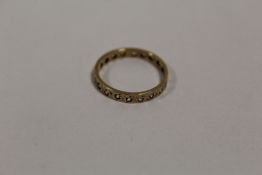A 9 CARAT GOLD ETERNITY RING