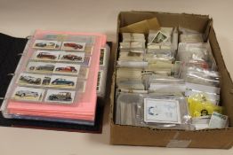 A LARGE QUANTITY OF CIGARETTE CARDS TO INCLUDE AN ALBUM AND CONTENTS