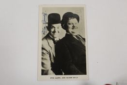 A SIGNED BLACK AND WHITE PHOTOGRAPH OF STAN LAUREL AND OLIVER HARDY (LAUREL & HARDY)