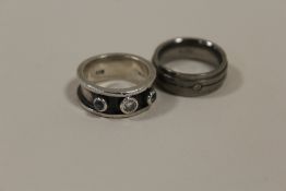 A HALLMARKED SILVER DRESS RING TOGETHER WITH A TITANIUM DIAMOND SET RING (2)