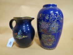 A VINTAGE CROWN DEVON CREAM JUG, blue ground with gilded decoration of an Oriental garden, H 14