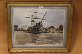 A GILT FRAMED AND GLAZED WATERCOLOUR OF A SAIL SHIP IN DOCK, INDISTINCTLY SIGNED LOWER LEFT