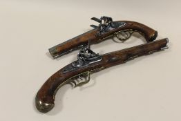A REPRODUCTION DOUBLE BARREL DECORATIVE FLINT LOCK PISTOL TOGETHER WITH A SINGLE BARREL EXAMPLE