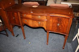 A MODERN MAHOGANY SERPENTINE FRONTED SIDEBOARD